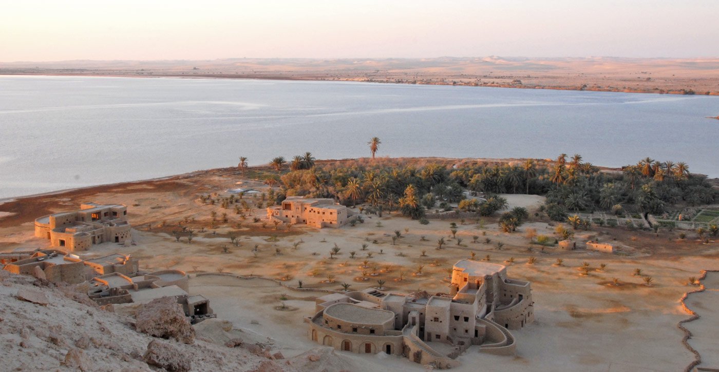 Aerial view of the kershef lodge and palm grove on the shore of the Siwan salt lake