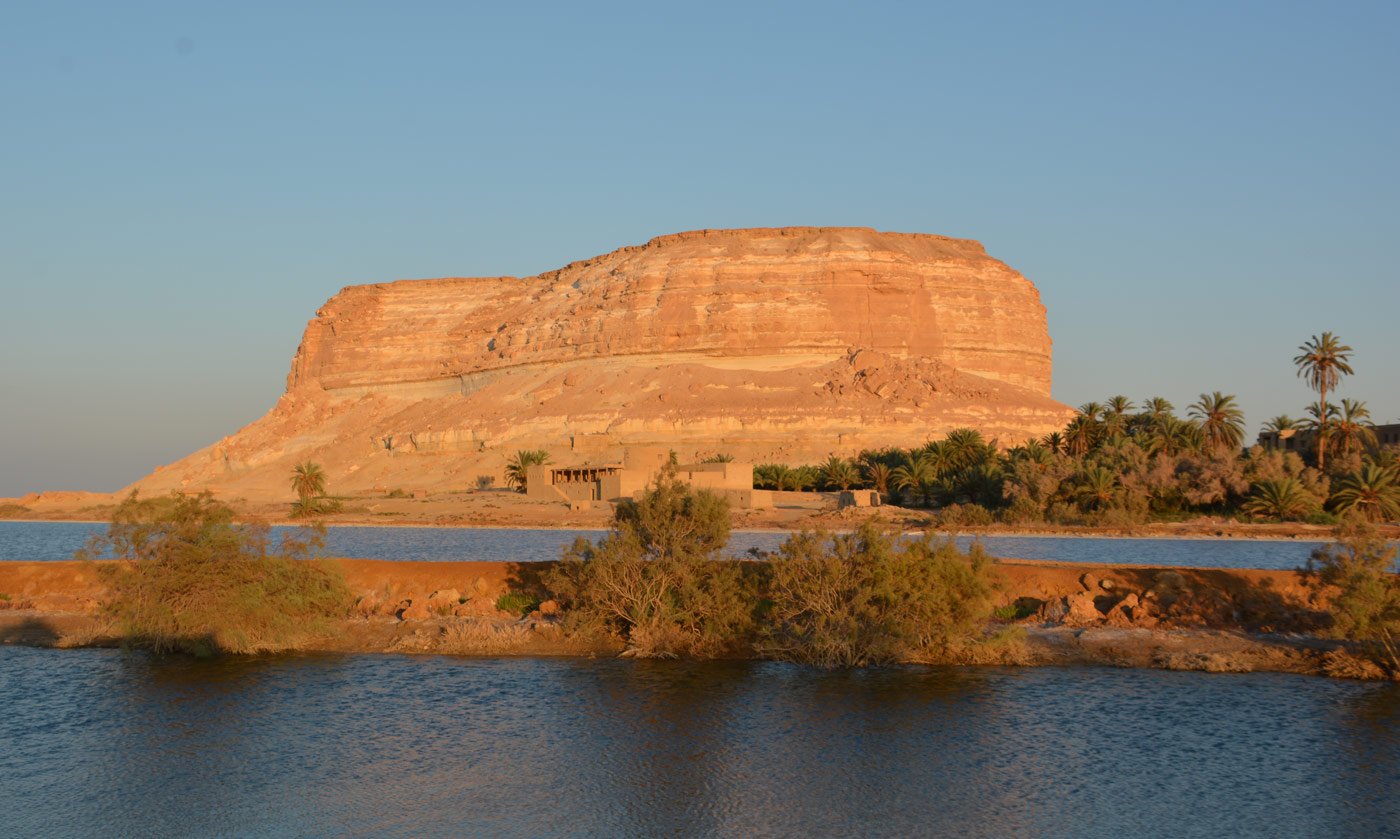 The White Mountain rising over the lake at Siwa