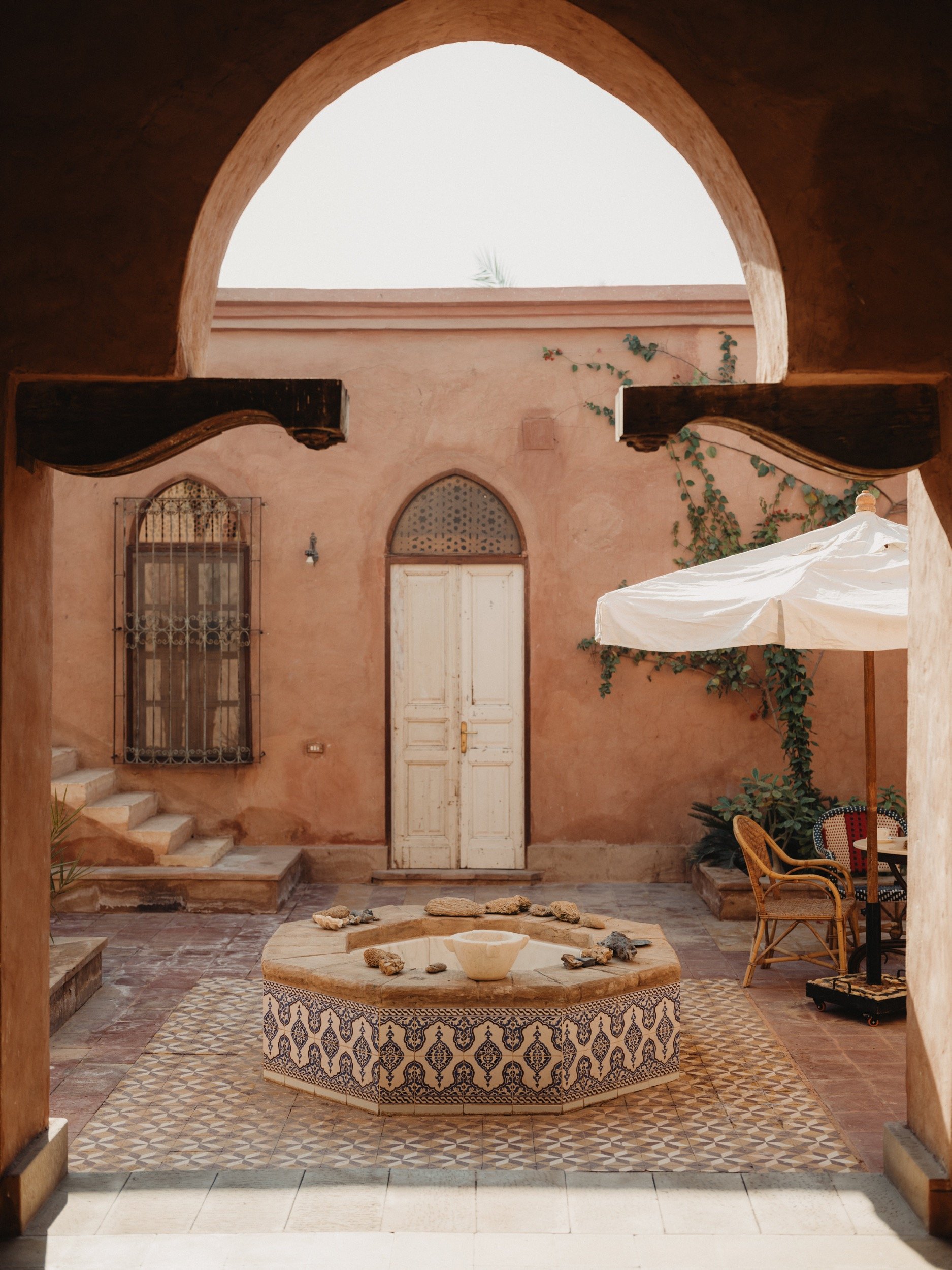 A private domed courtyard set with cushions and a low table
