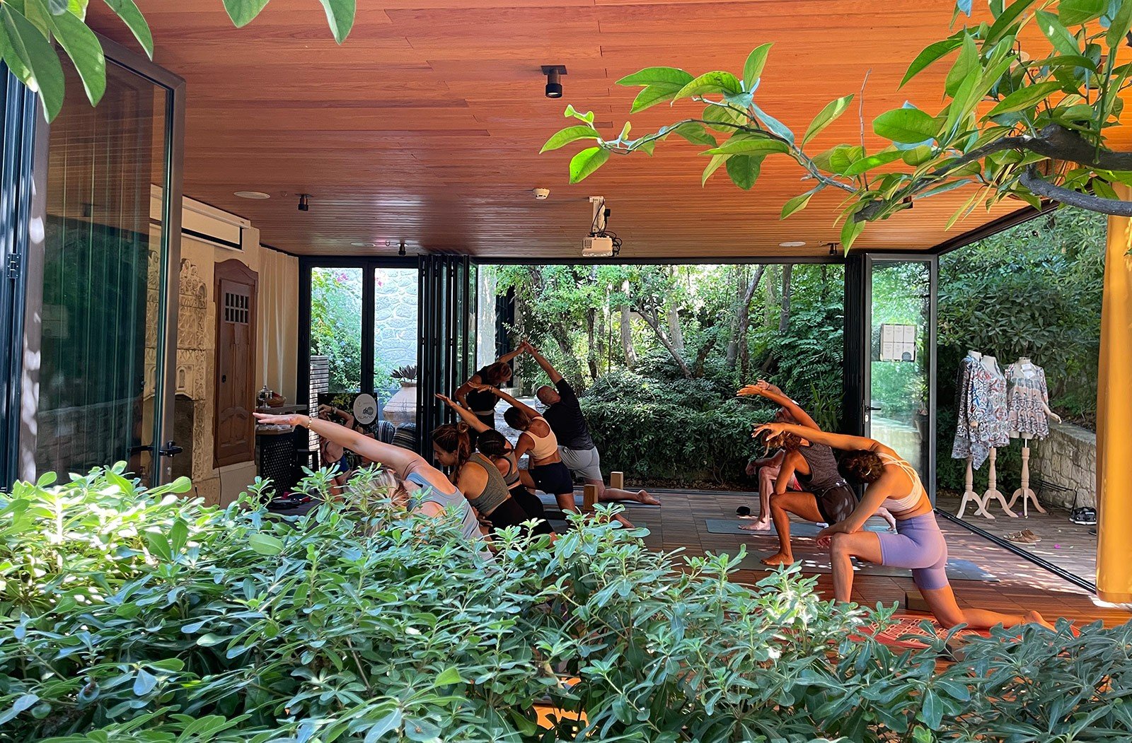 A garden pavilion open to the greenery for yoga and stretching