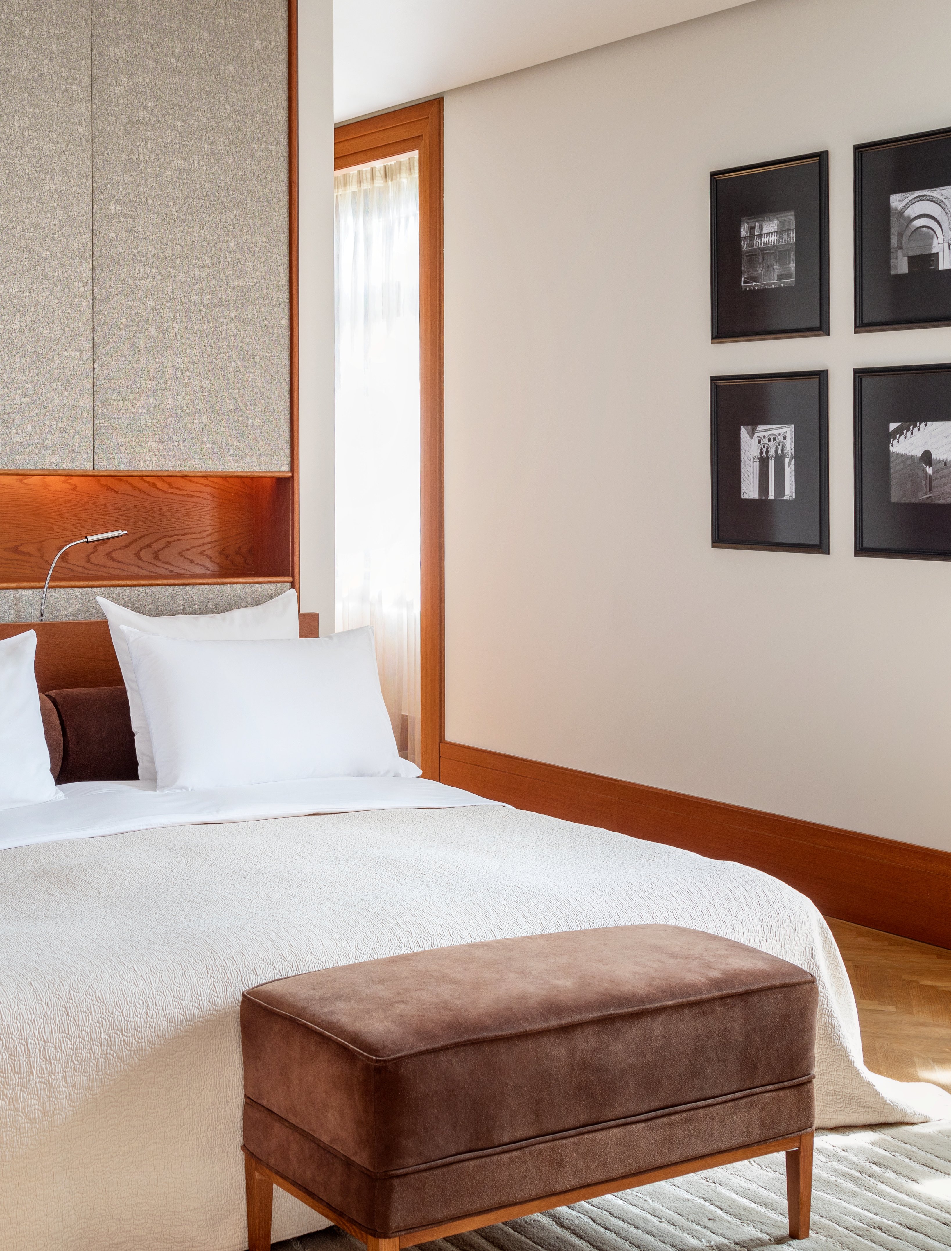 A suite bedroom in oak and cream linen at Villa Miločer