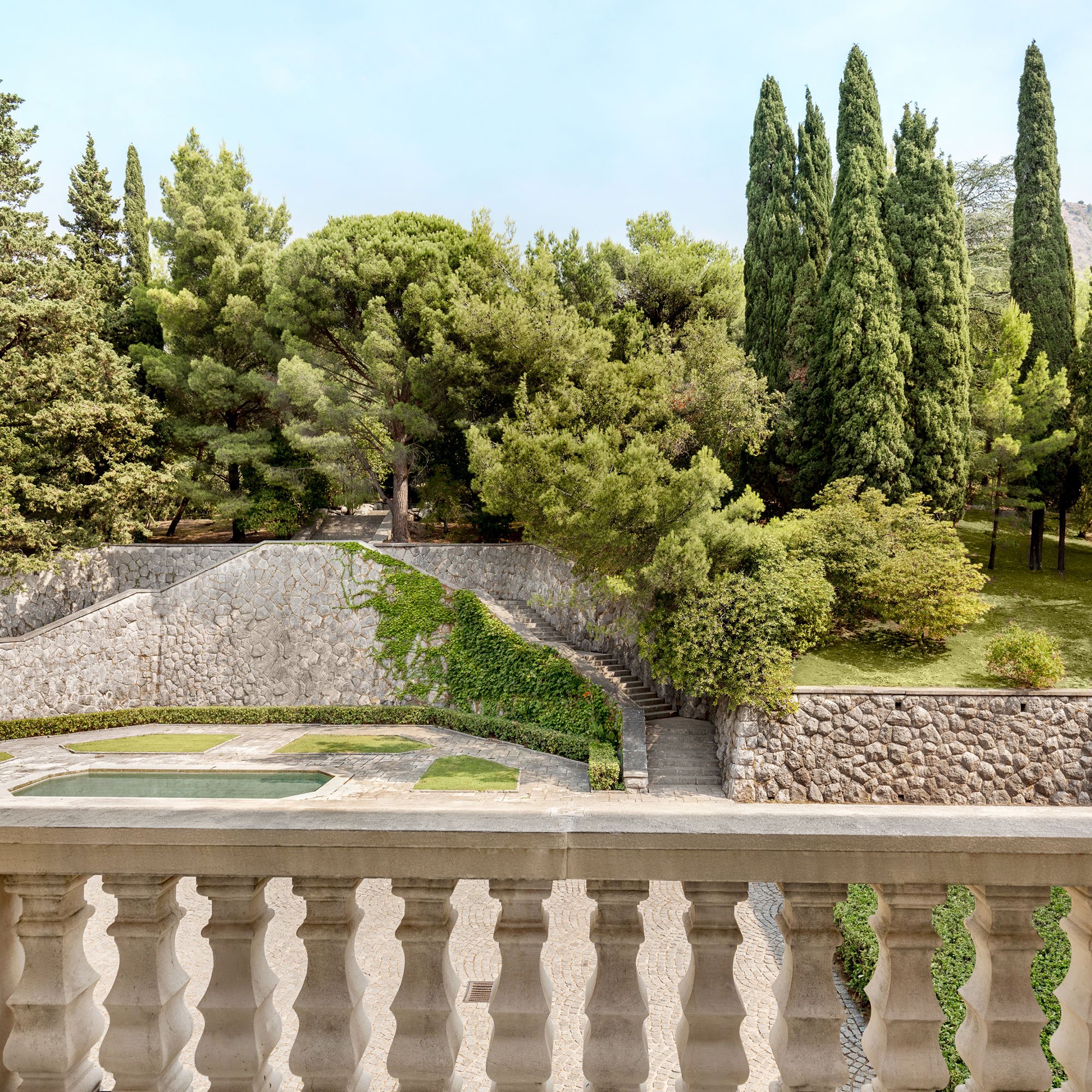 The gardens and old bathing pool below a Villa Miločer balcony