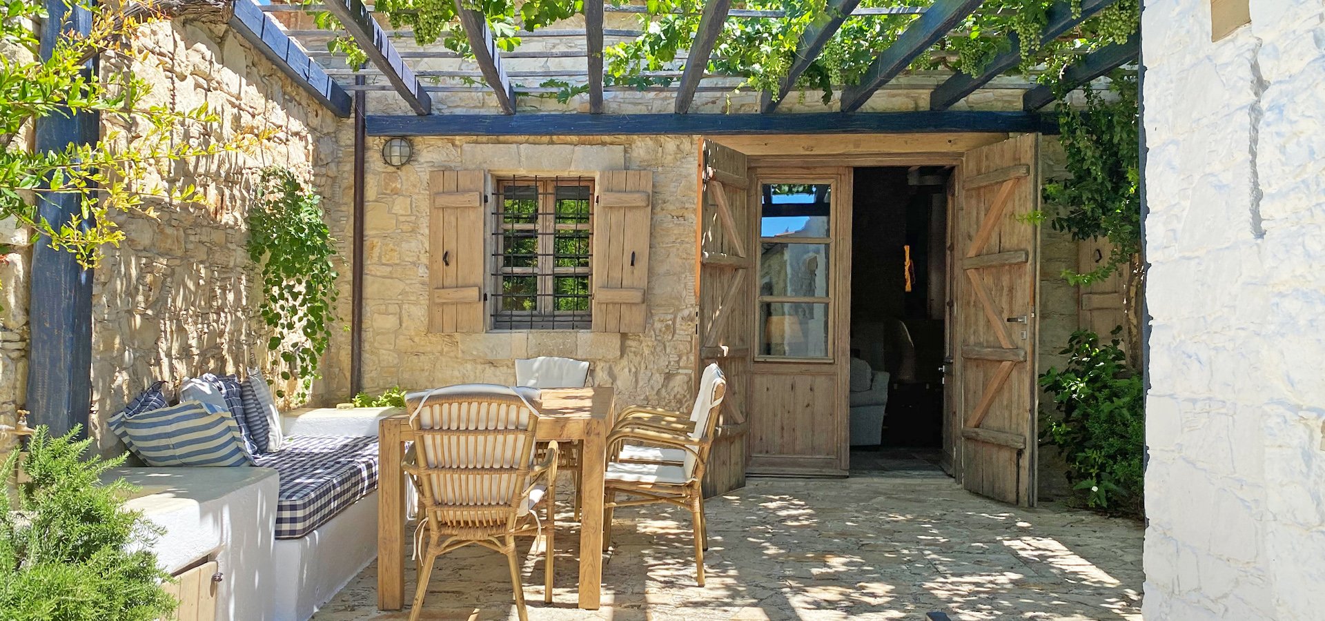 A private courtyard under a vine-covered pergola