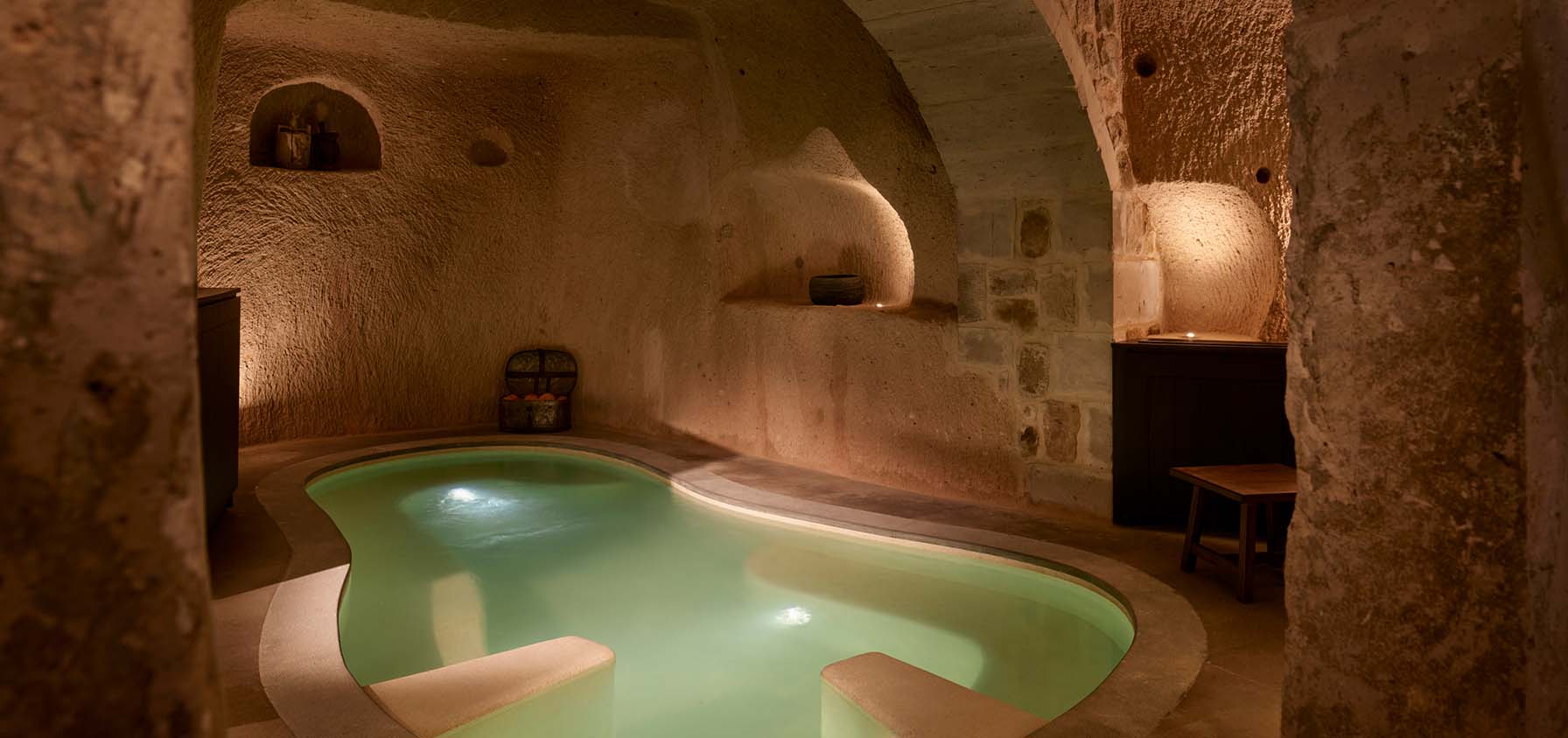 A small pool set into the floor of a cave suite