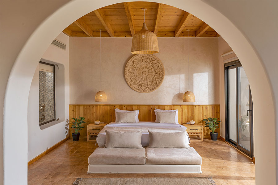 A Nubian room with a vaulted wooden ceiling, carved plaster rosette and platform bed