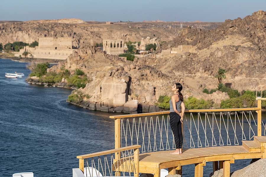 A yoga deck above the Nile looking across to ancient ruins on the far bank