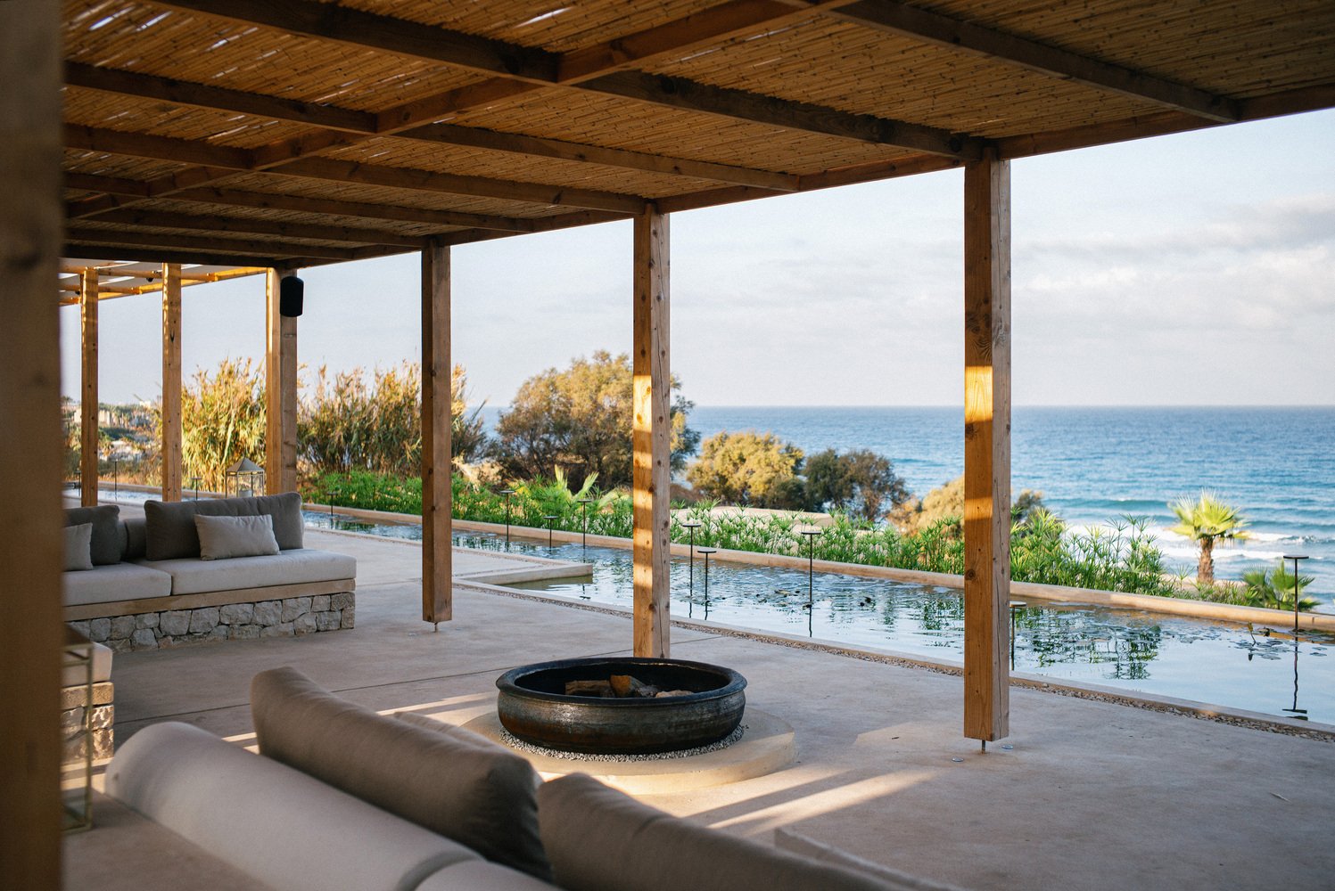 A shaded lounge opening onto a pool and the Mediterranean