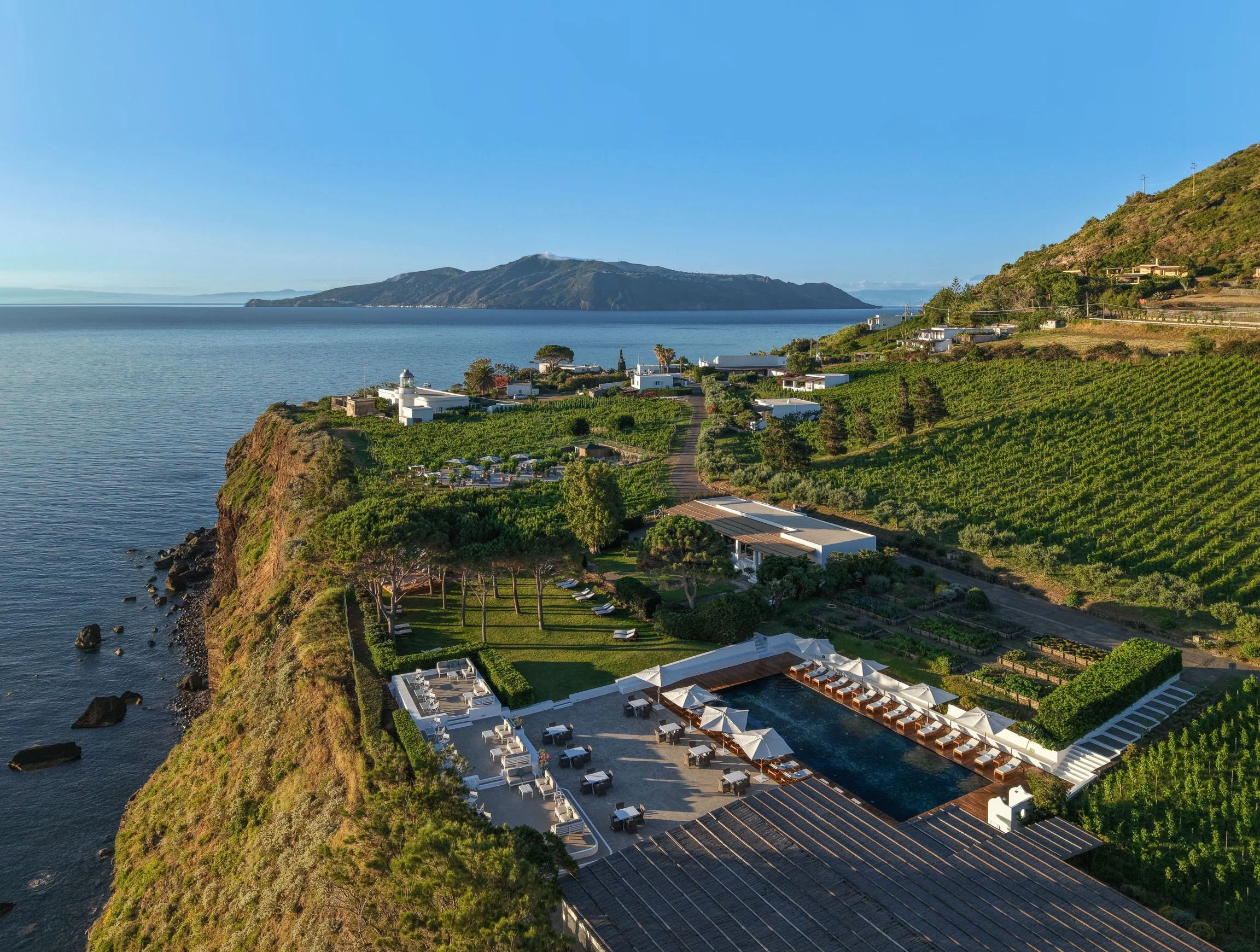 The estate and pool set among the vineyard above the sea