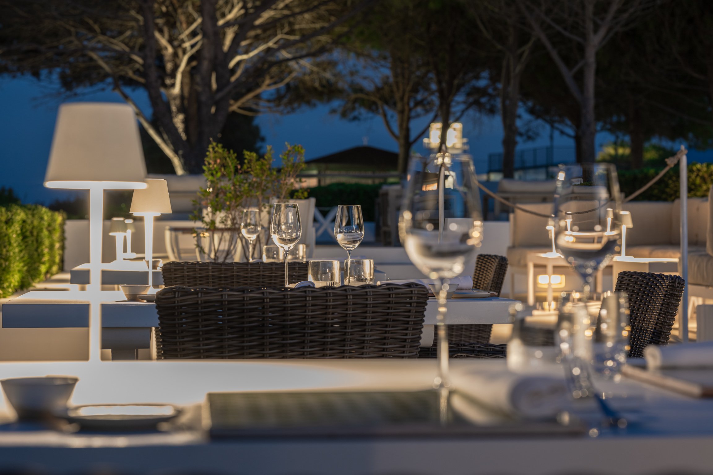 A table laid on the sea terrace at dusk