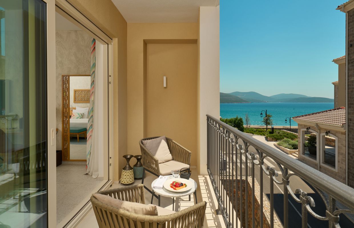 Breakfast set on a room balcony looking over the marina to the bay
