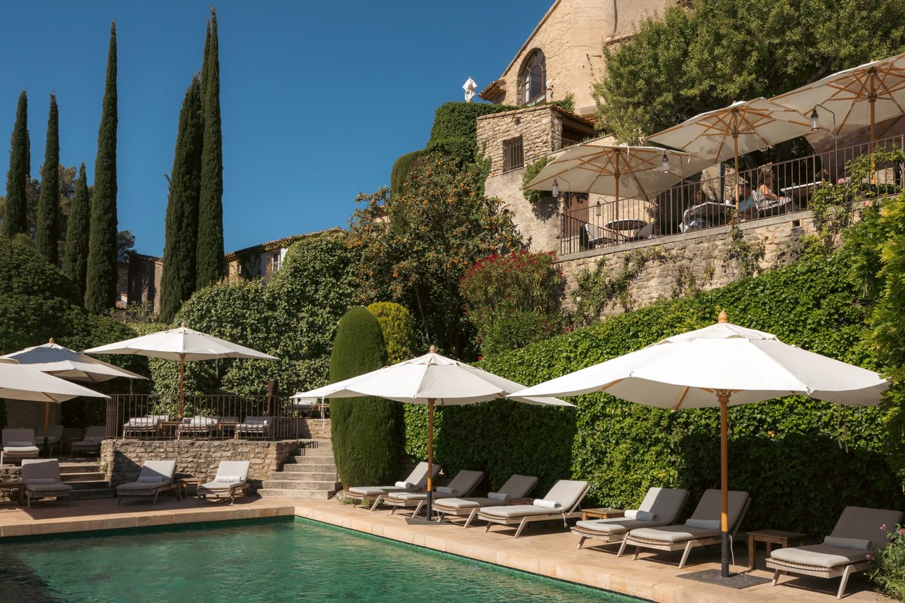 The hotel pool below the stone terraces of the village, looking out to the valley