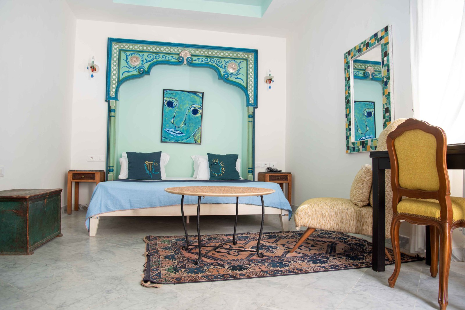 A room with a carved headboard alcove painted in deep blue and set with tiles
