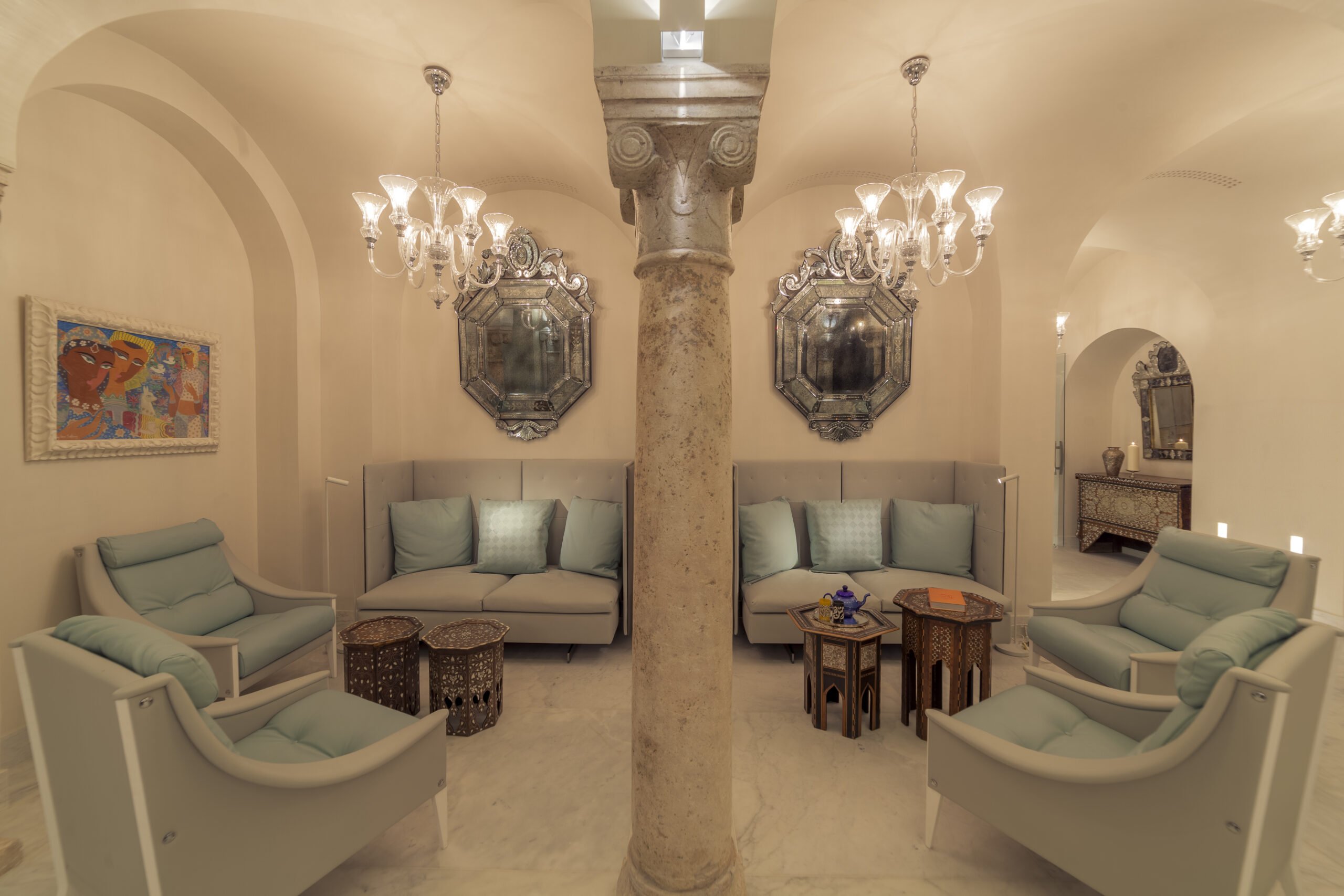 A vaulted salon with antique mirrors and old stone columns