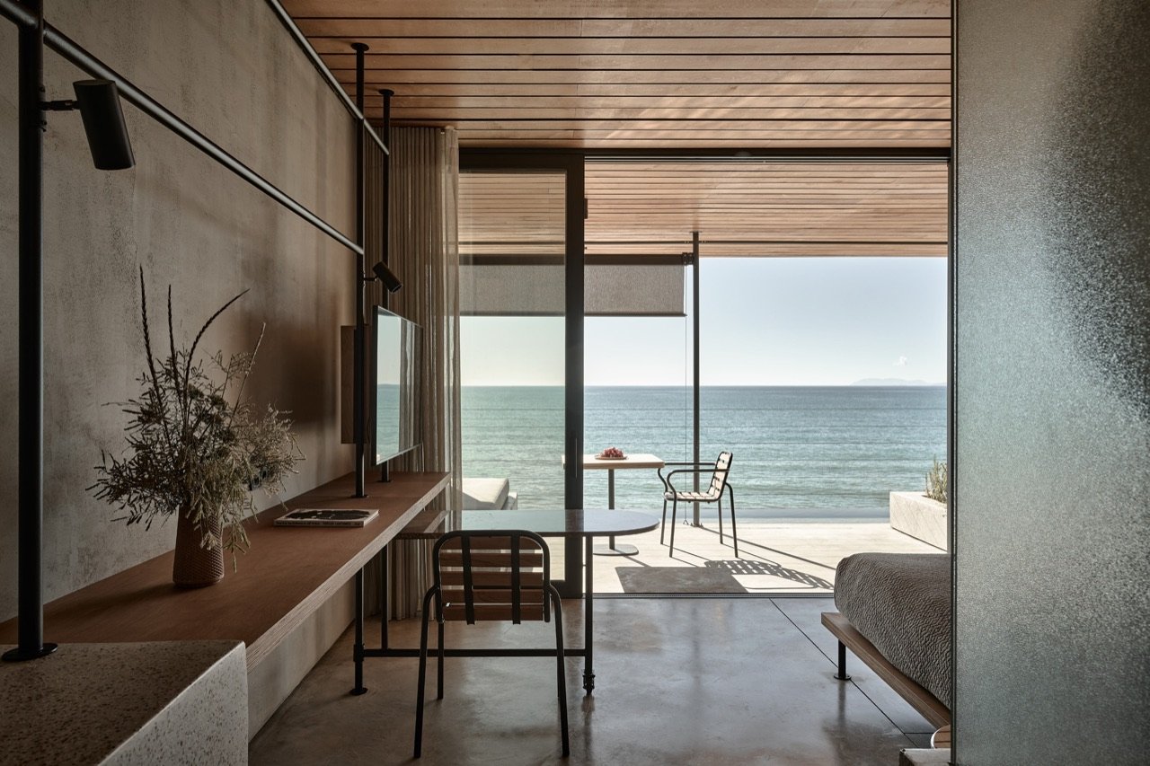 A tank-suite interior, bare concrete and linen