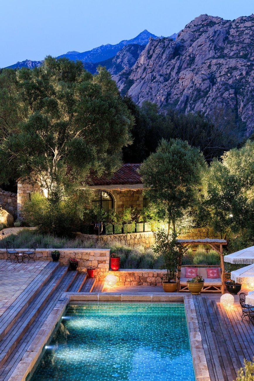 A stone-edged pool at dusk below the granite mountains of the valley