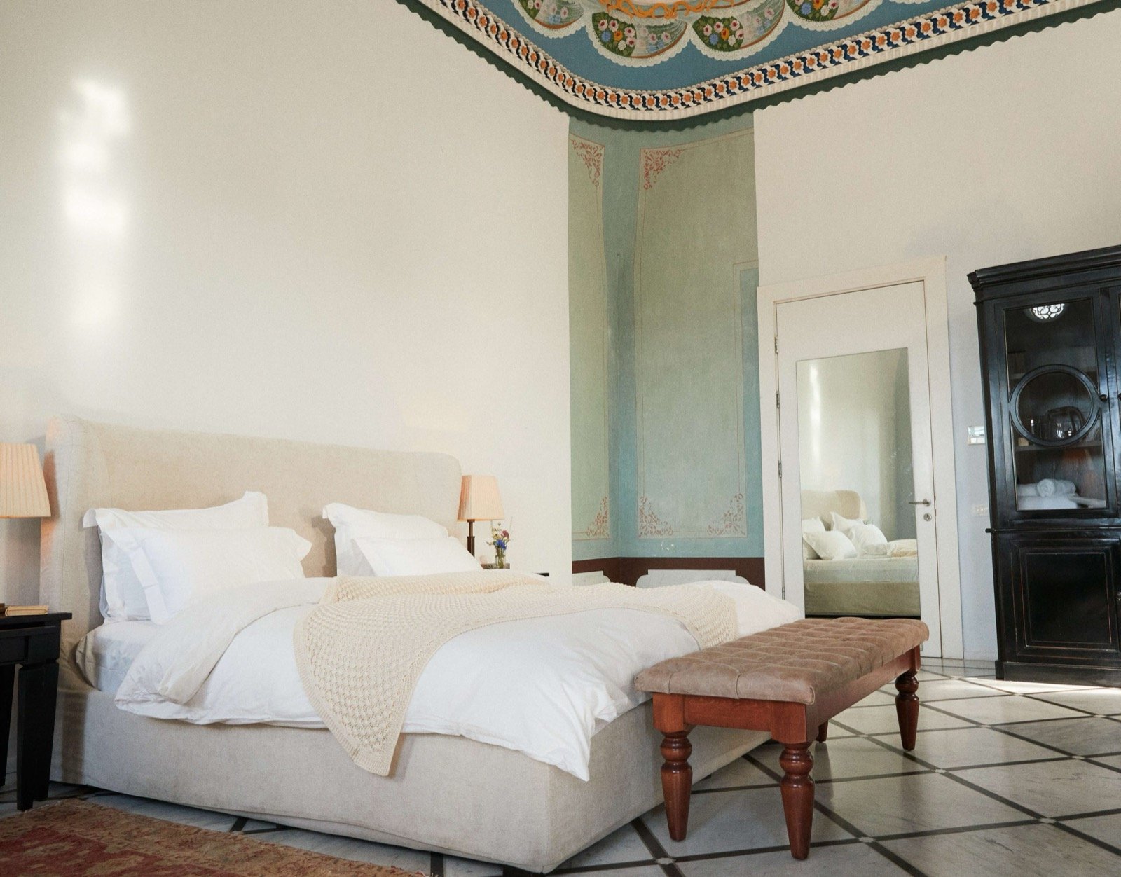 A bedroom beneath a restored Ottoman painted ceiling