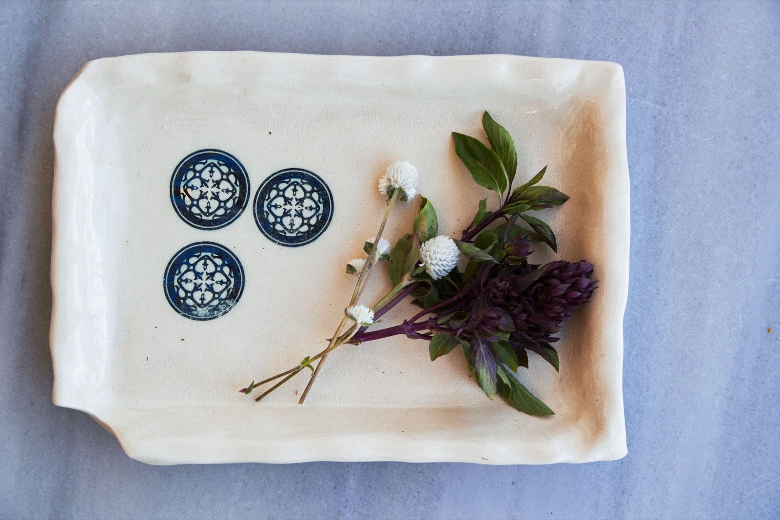 A local ceramic dish with herbs, part of the table setting
