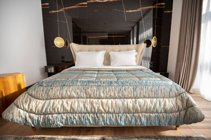 Executive suite with a satin bedspread at Empire Beach Resort