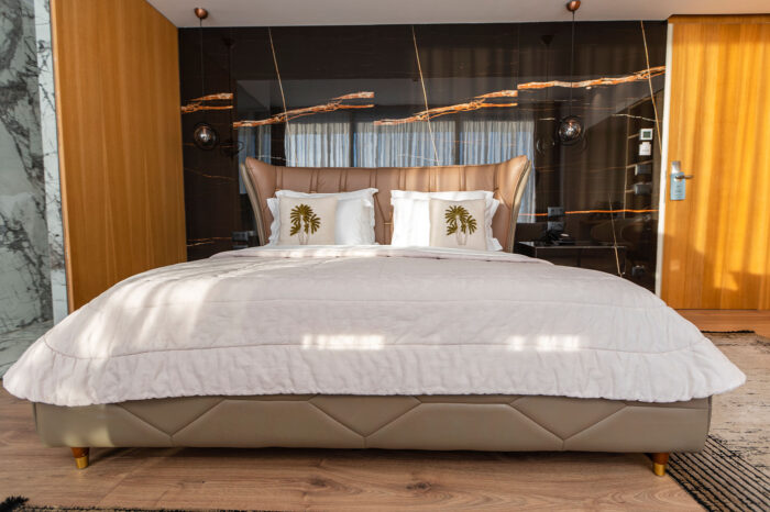 Junior suite with warm wood panelling at Empire Beach Resort