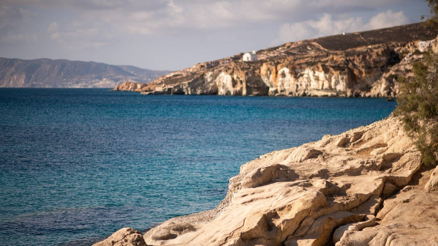 The coast of Kimolos, a white chapel above the bay