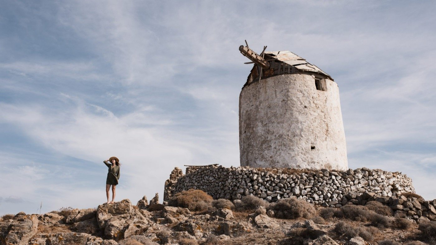 An old stone windmill on the ridge above the sea