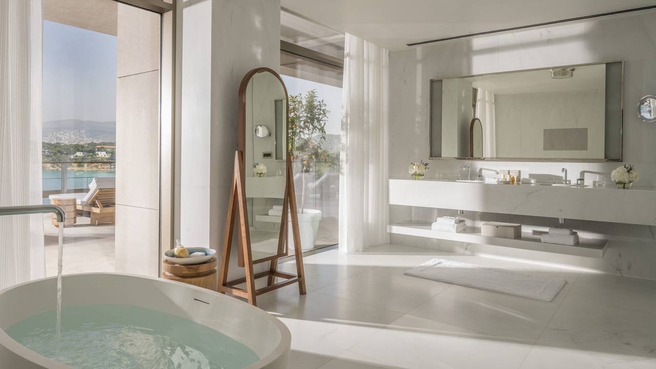 Marble bathroom with freestanding tub and sea view