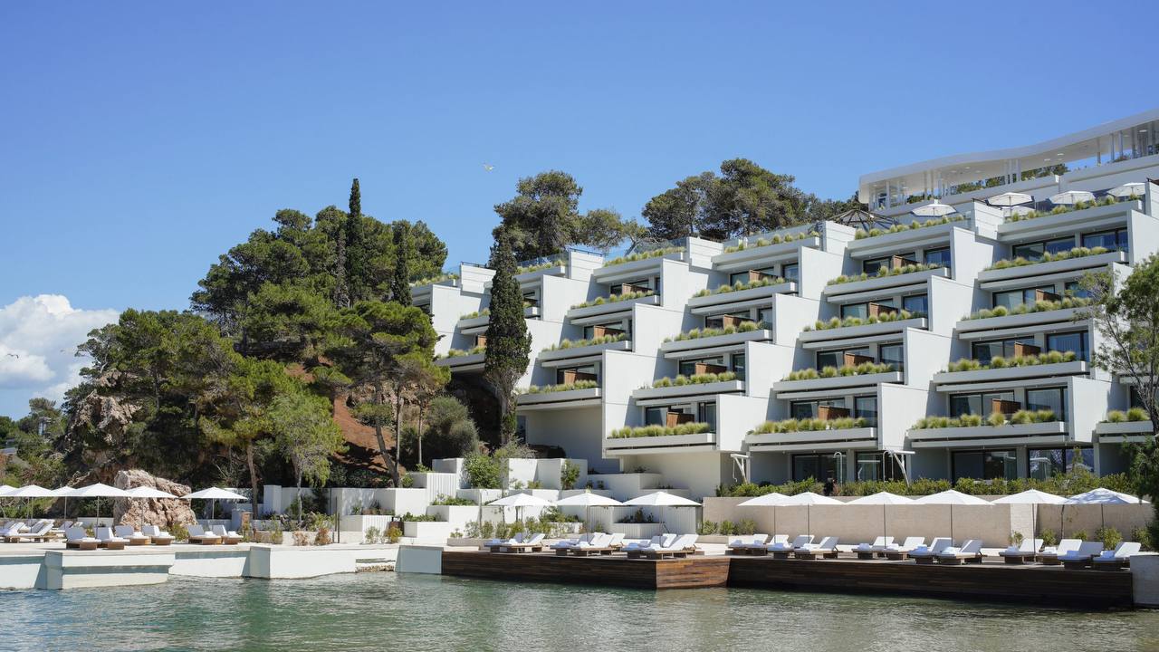 Stepped white balconies and seafront sun decks at Four Seasons Astir Palace