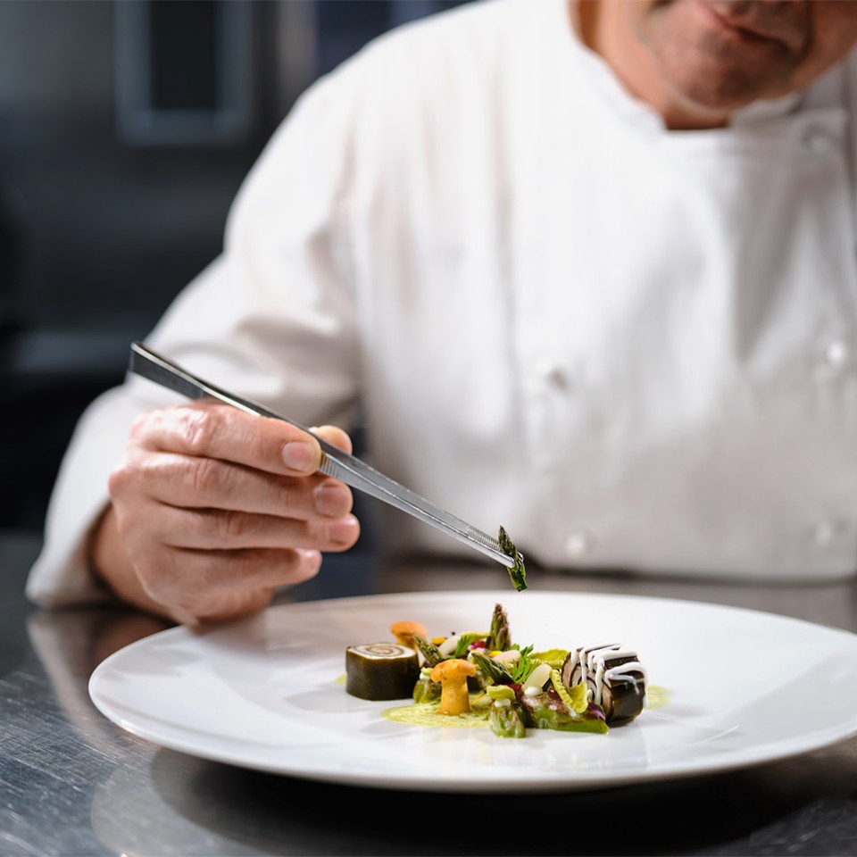 The chef plating a dish at the Otočec Castle Restaurant