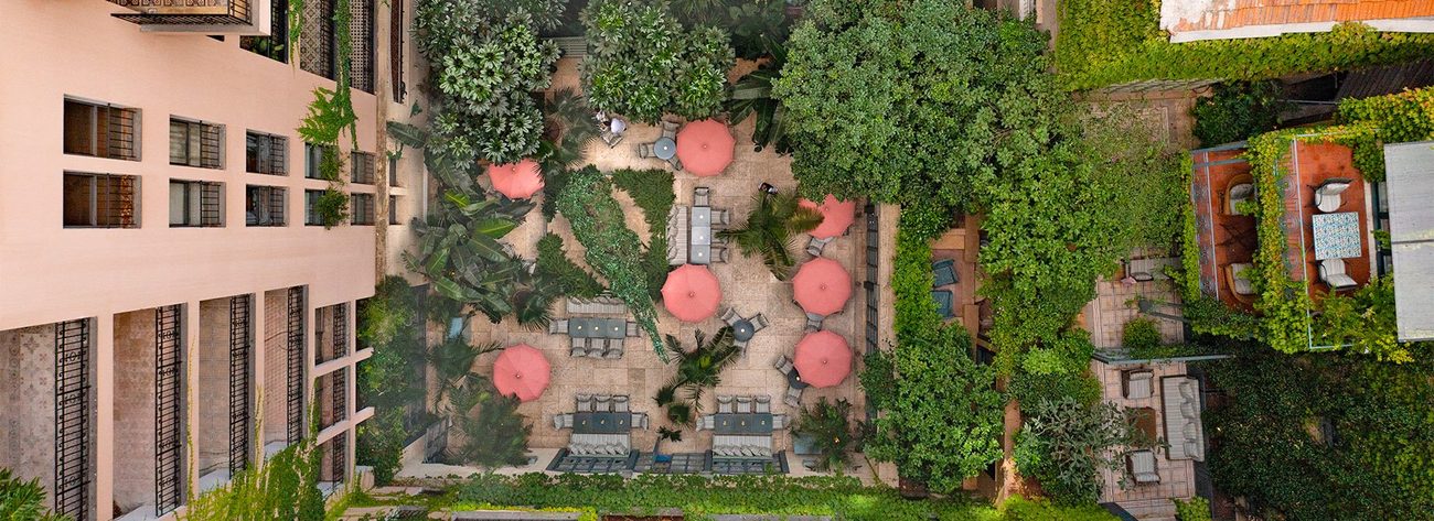 Looking down on the courtyard garden with its parasols and trees