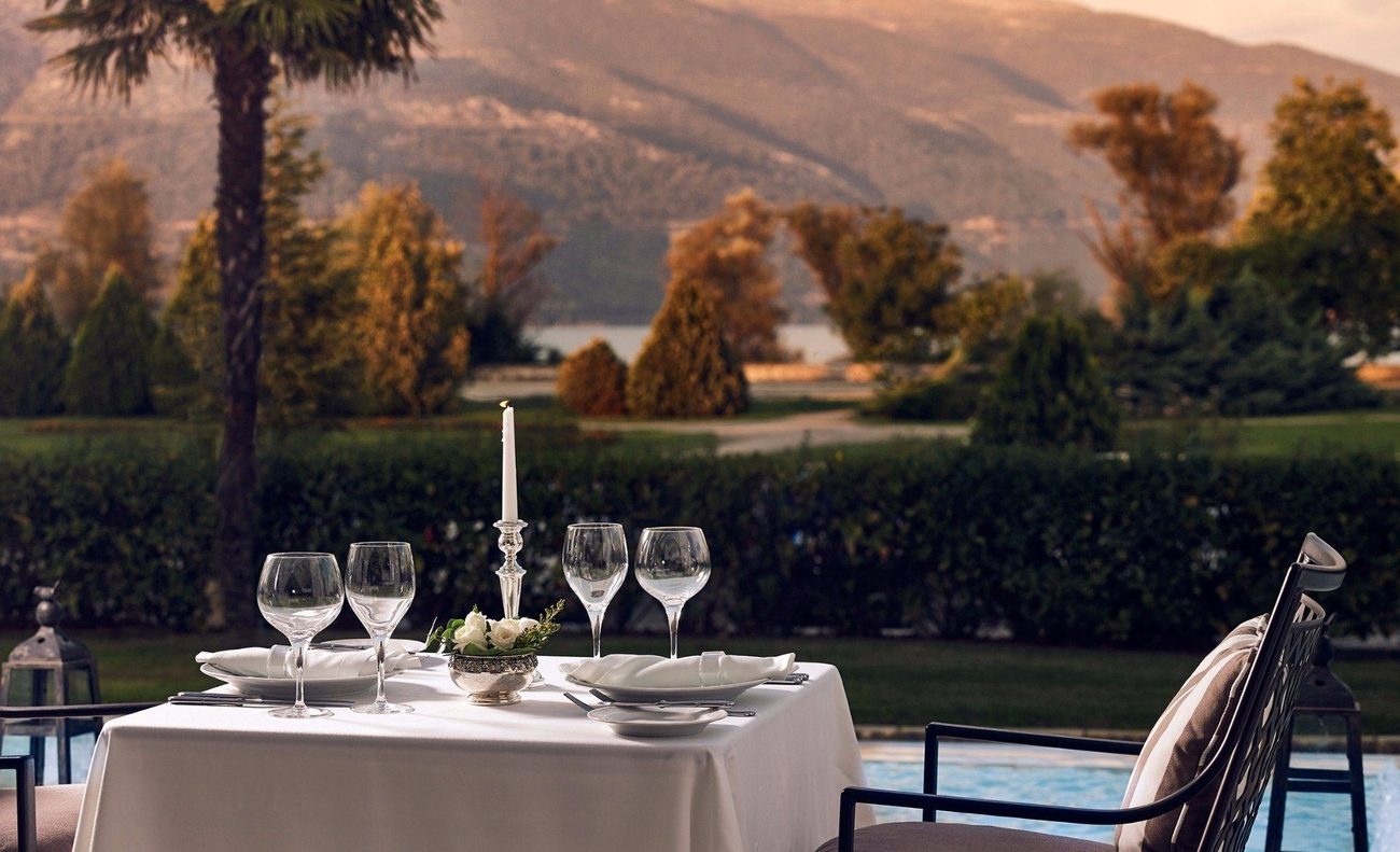 A table laid for dinner with Lake Pamvotida and the mountains beyond