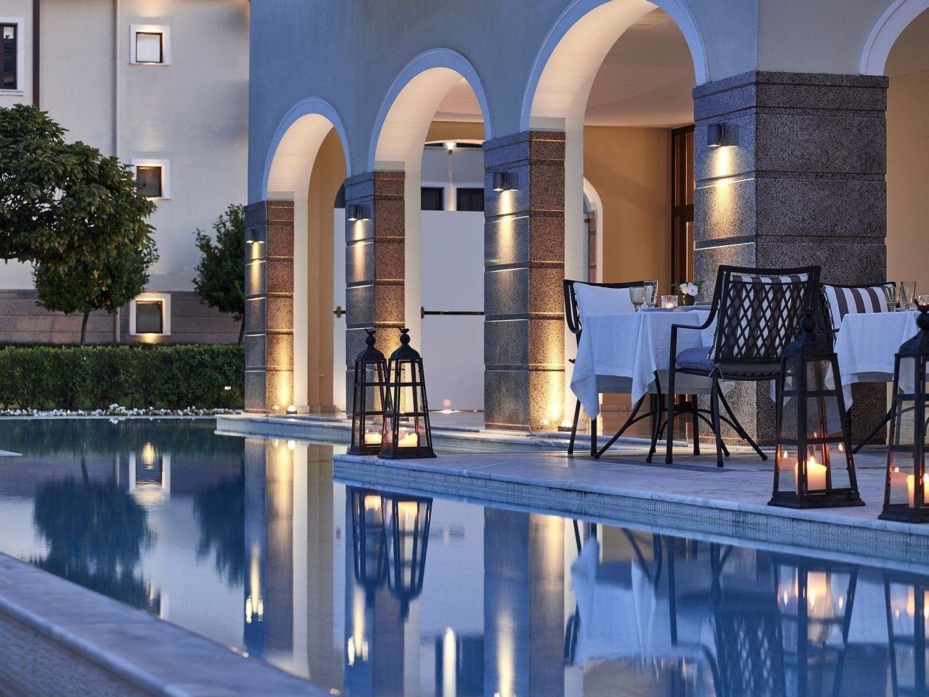 Poolside dining under the arcade at dusk