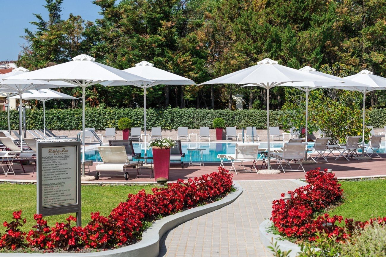 The outdoor pool with loungers and garden beds