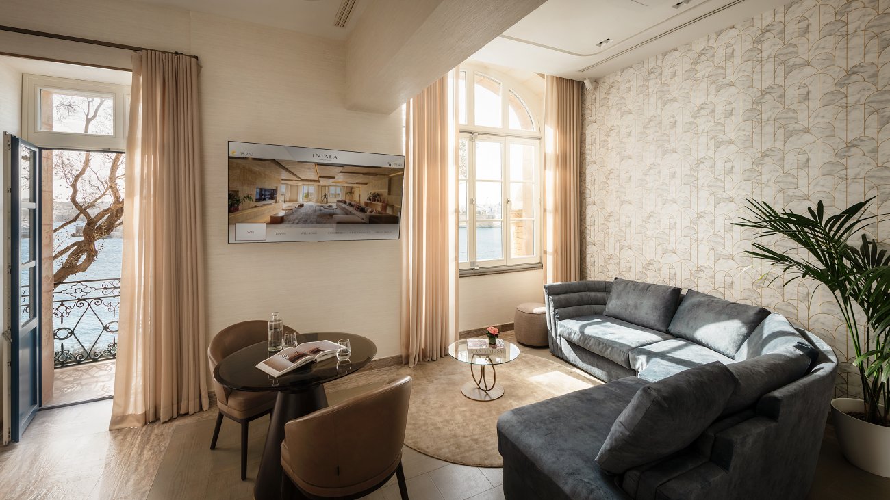 A sitting room with a traditional Maltese balcony opening to the harbour