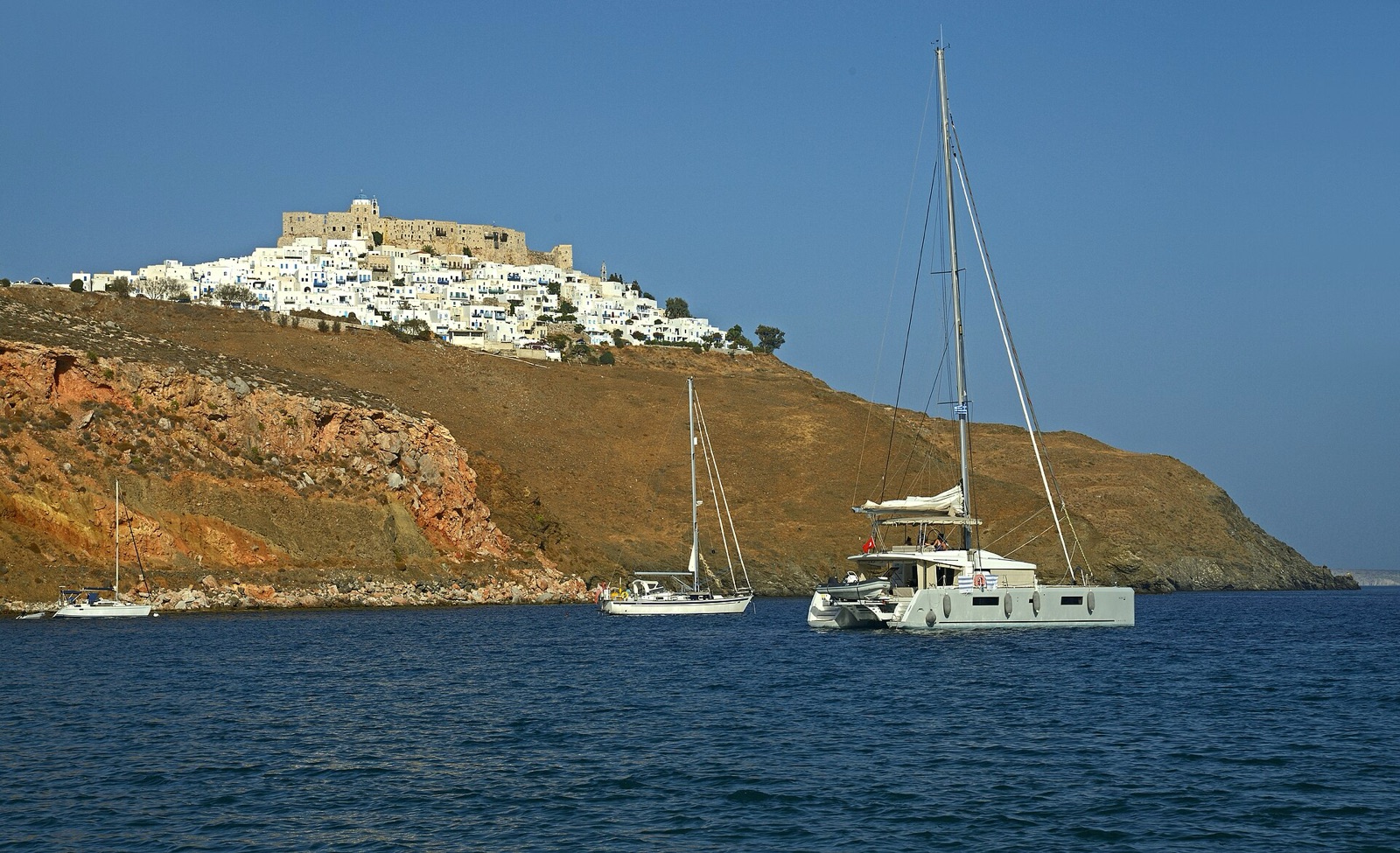Yachts moored below the whitewashed Chora of Astypalaia