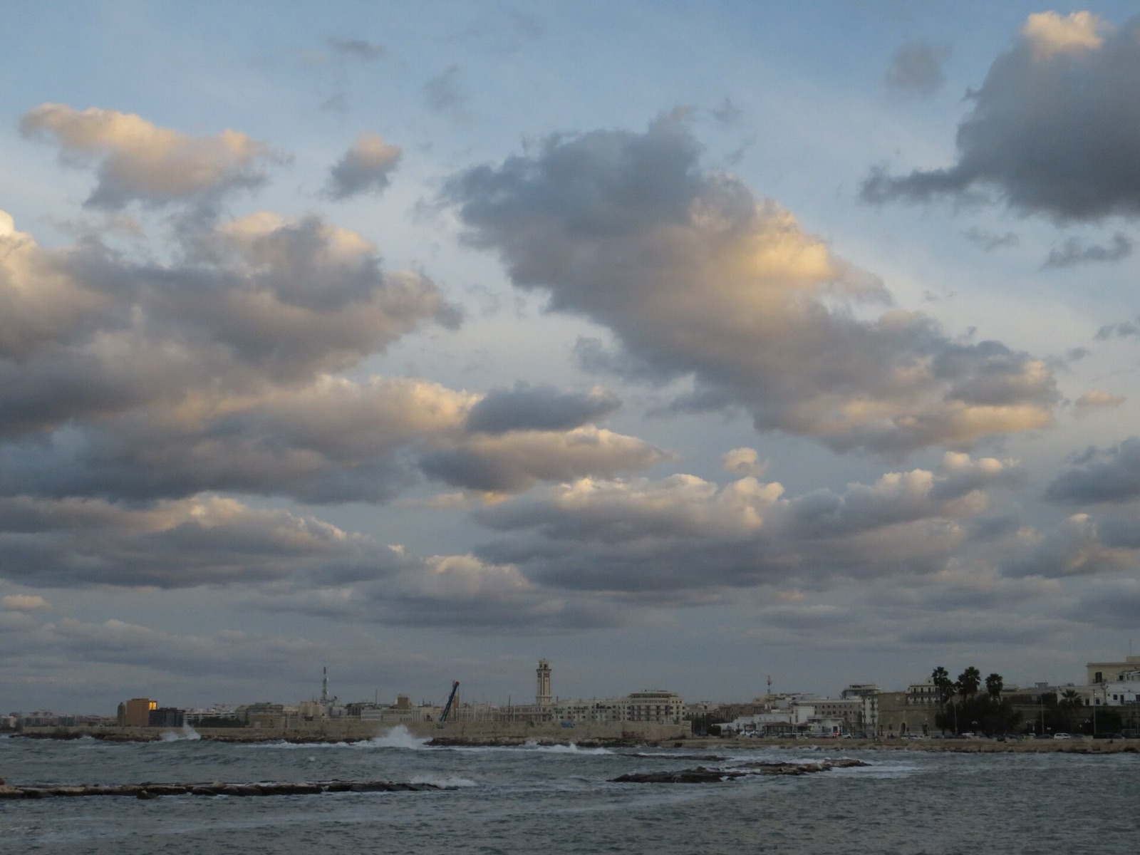 The seafront promenade of Bari under a broken sky