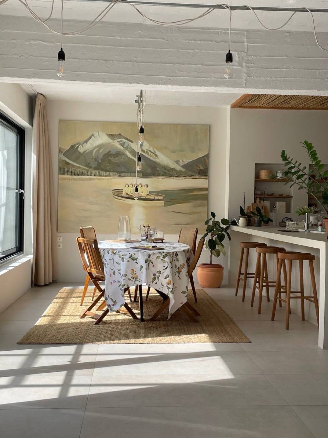 The dining table in morning light, beneath the lake painting
