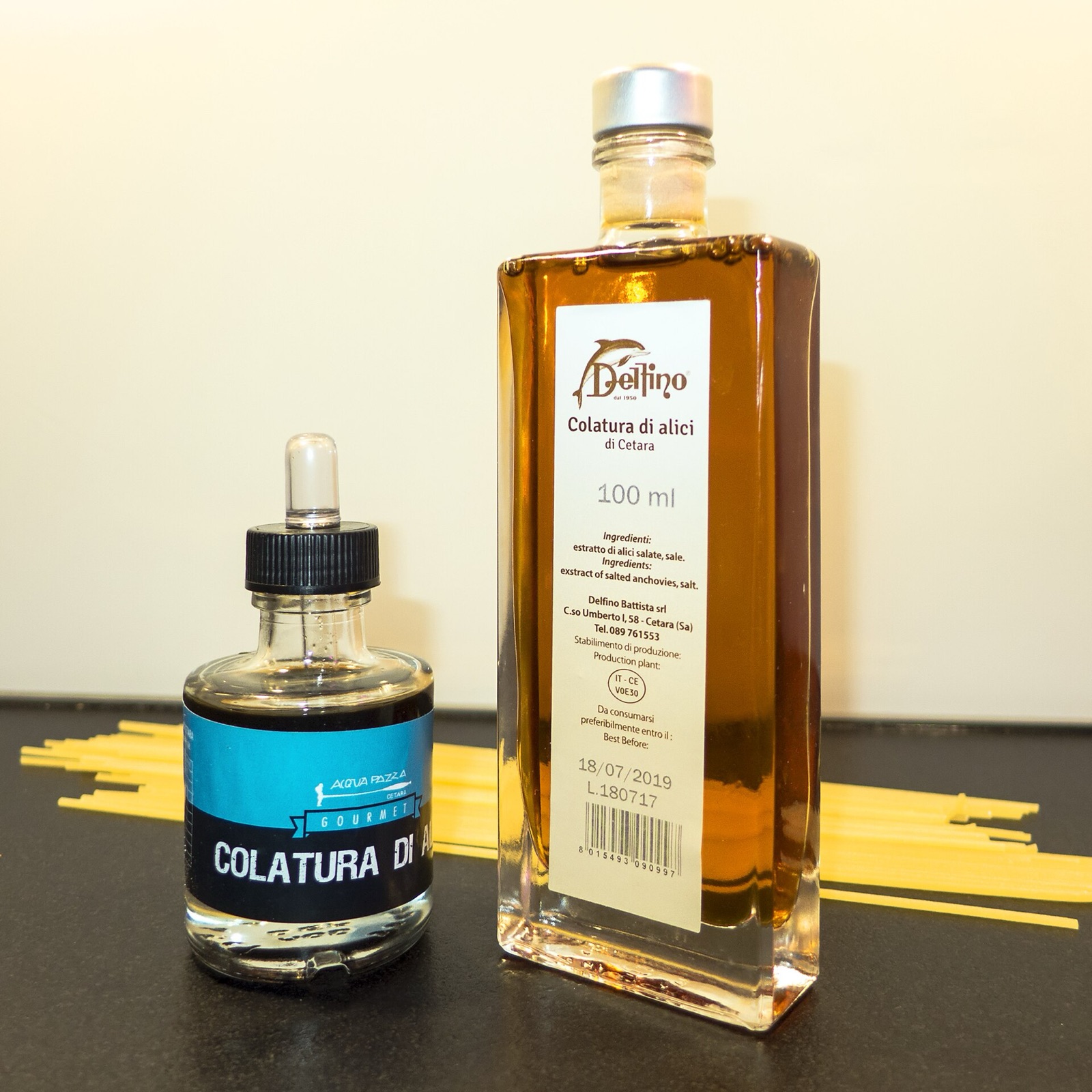 Colatura di alici, the amber anchovy sauce, in a glass