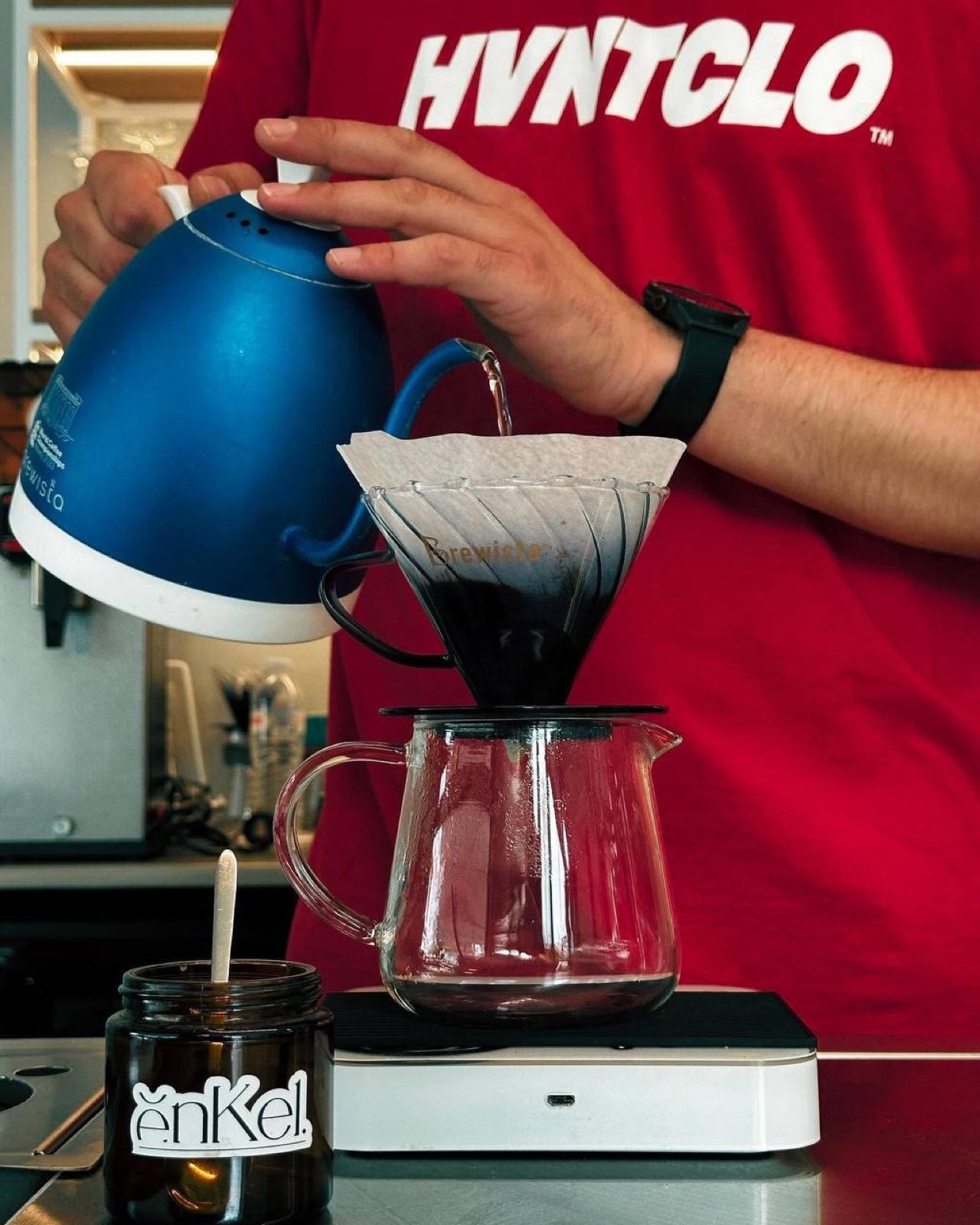 A Brewista pour over at the bar, beside the enkel jar