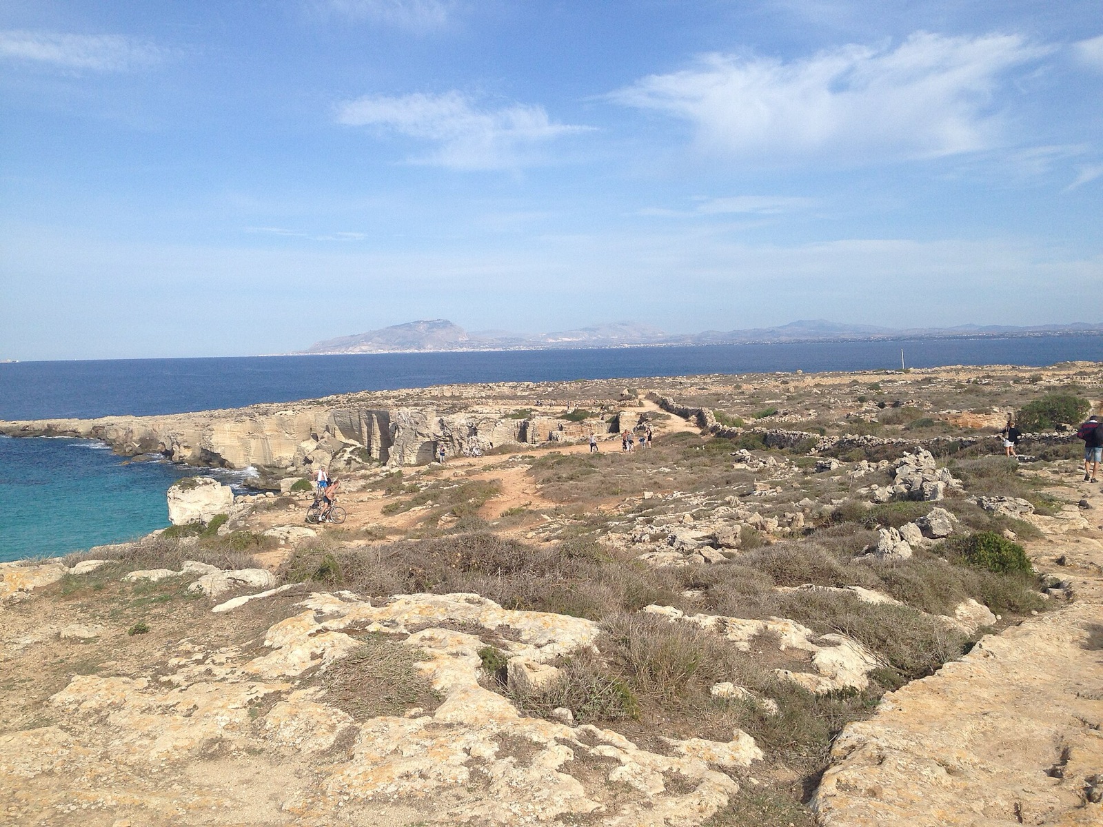 The turquoise water of Cala Rossa, ringed by old quarry cliffs