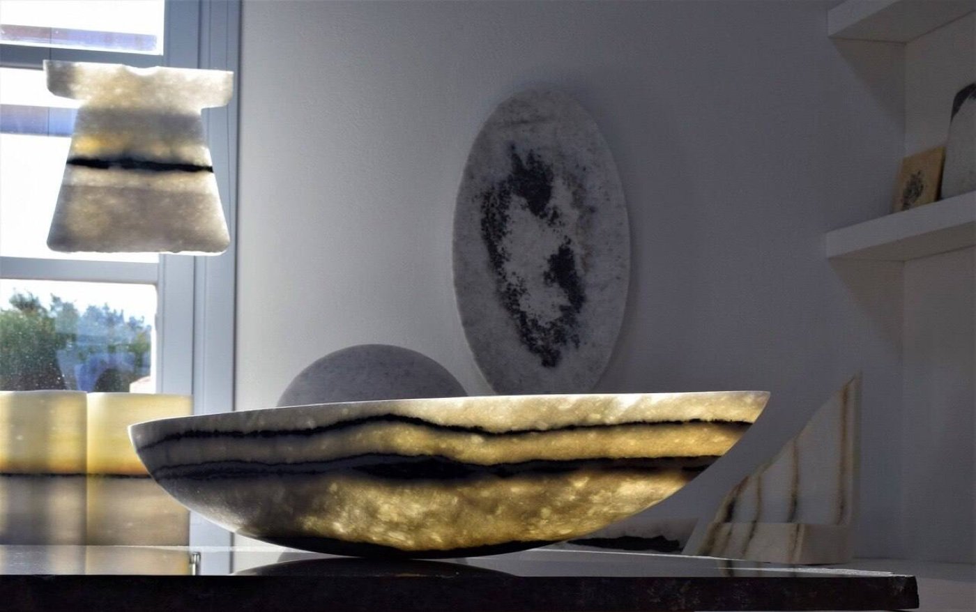 Several of Brunk's marble works in his Naxos studio, a bowl, a sphere and a wall piece