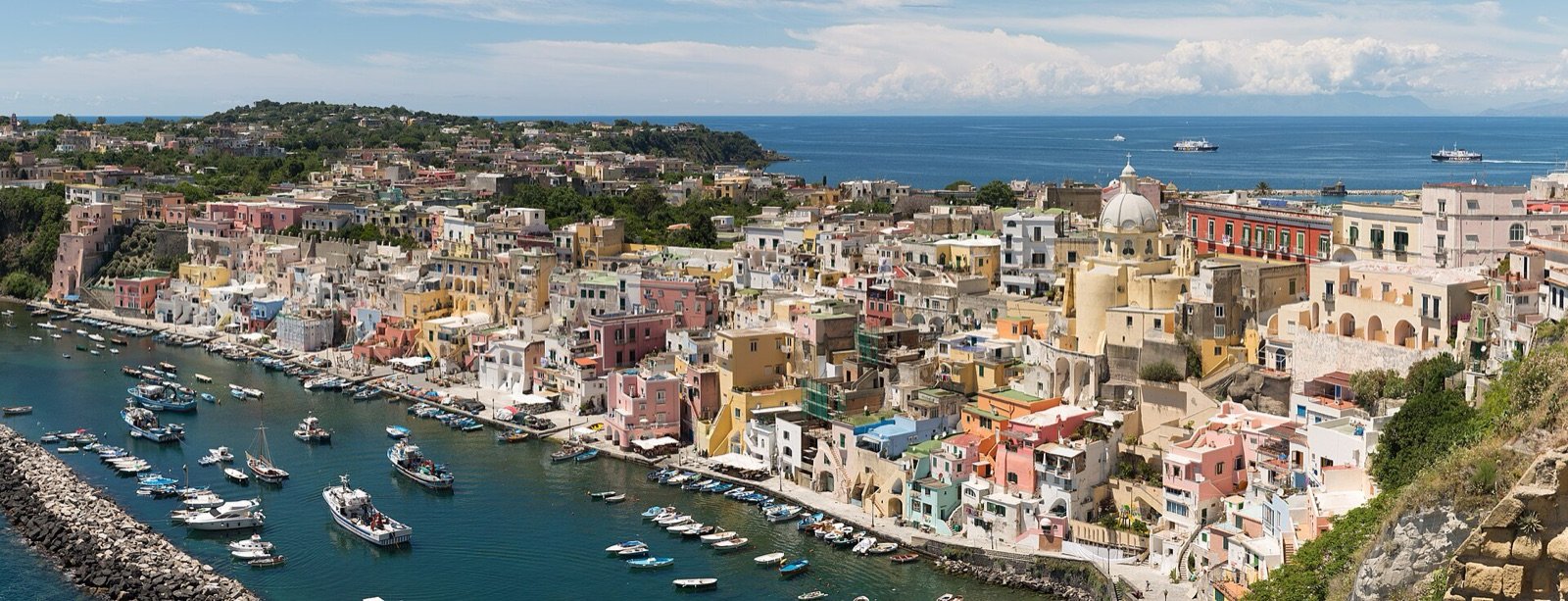 Fishing boats and pastel houses in the port of Corricella, Procida