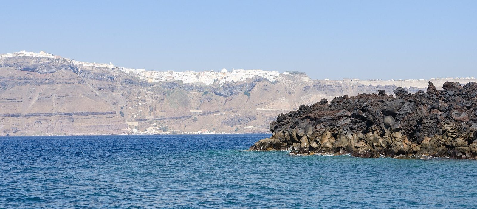 Basaltic lava on Nea Kameni with the Santorini caldera beyond