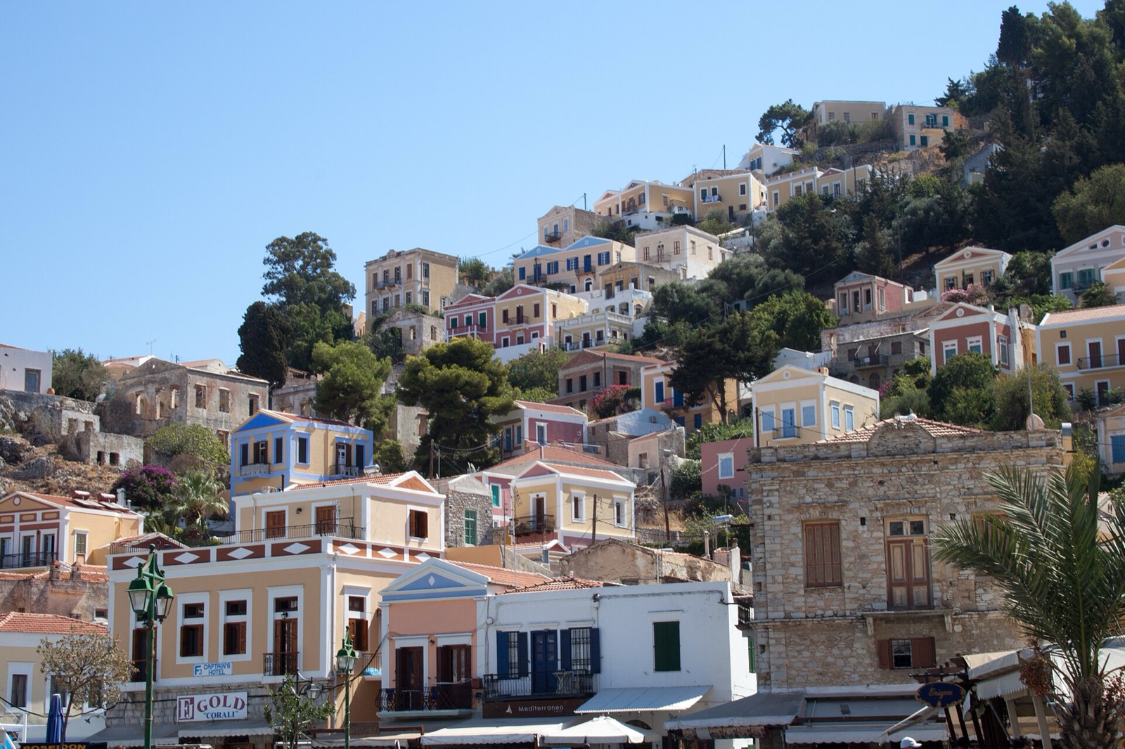 Detail of painted neoclassical facades on the slope at Symi