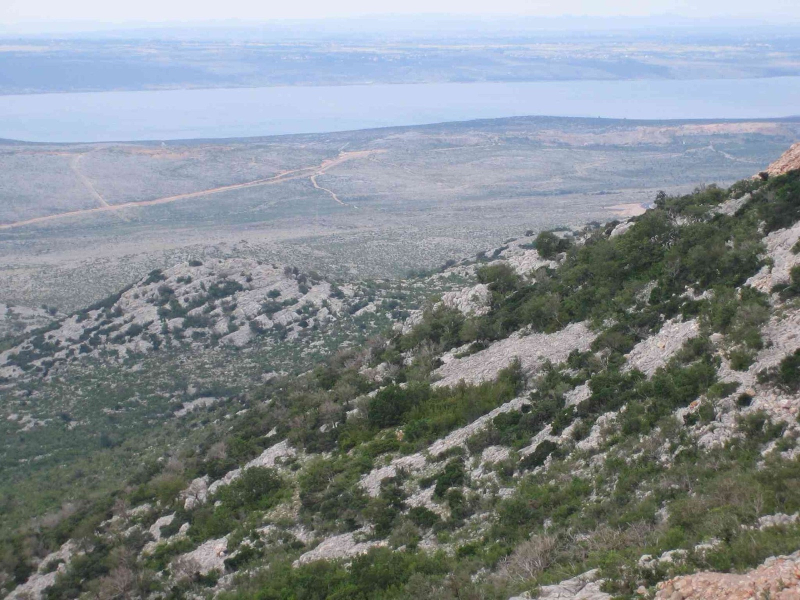 Bare karst at the foot of the Velebit, shaped by the bora, with the island of Pag beyond