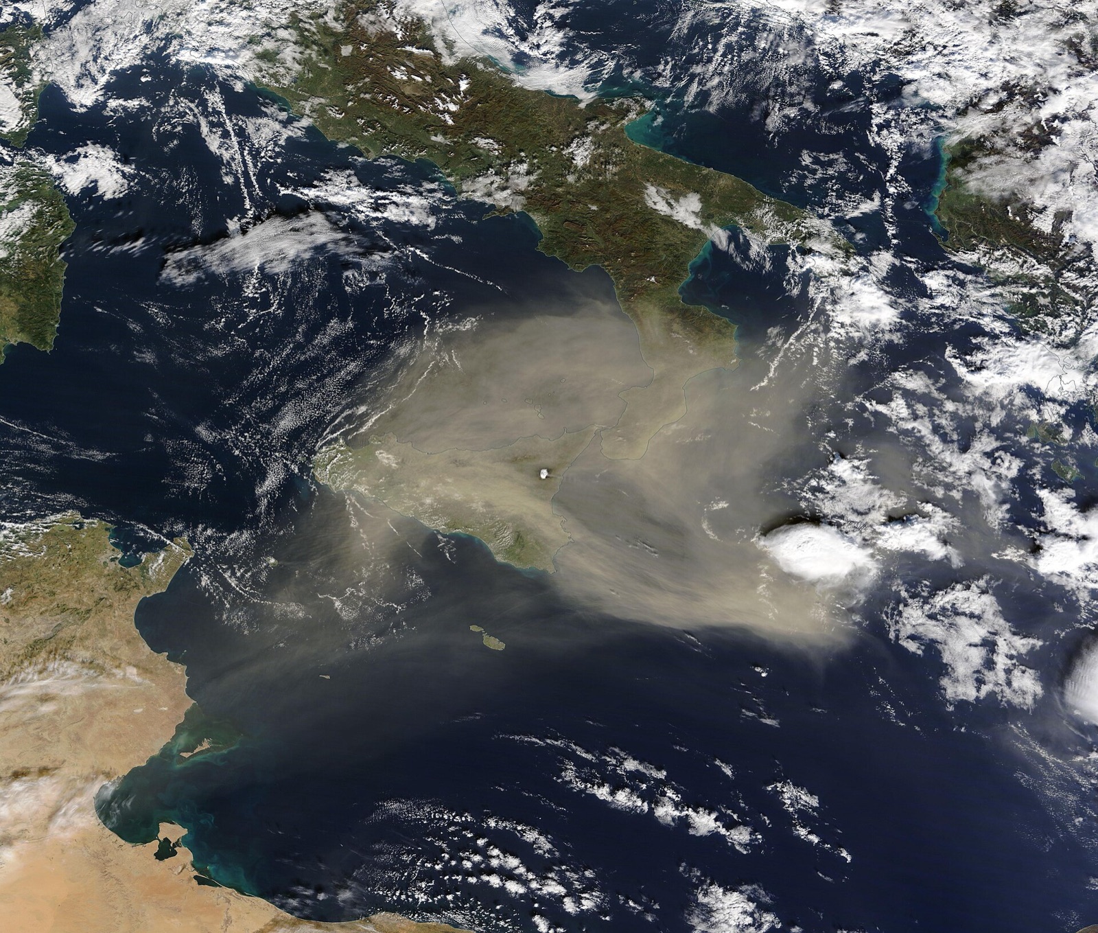How a hot wind off the desert crosses the sea, turns humid, and drops red rain on the ston