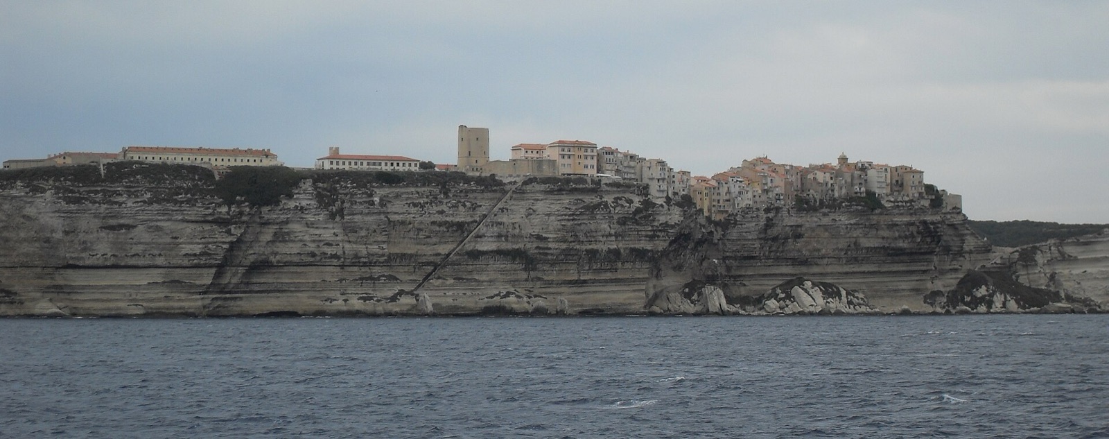 Approaching the town of Bonifacio from the sea, white cliffs rising above the channel