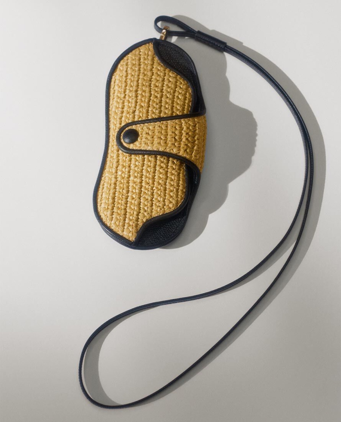 A Milanese leather house, an engineer's austerity, and the bag built to the exact shape of