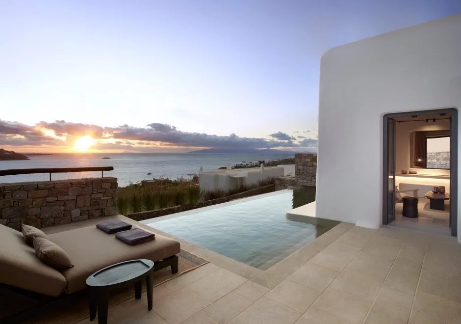 A suite's private pool terrace at Kalesma Mykonos at sunrise, the Aegean beyond
