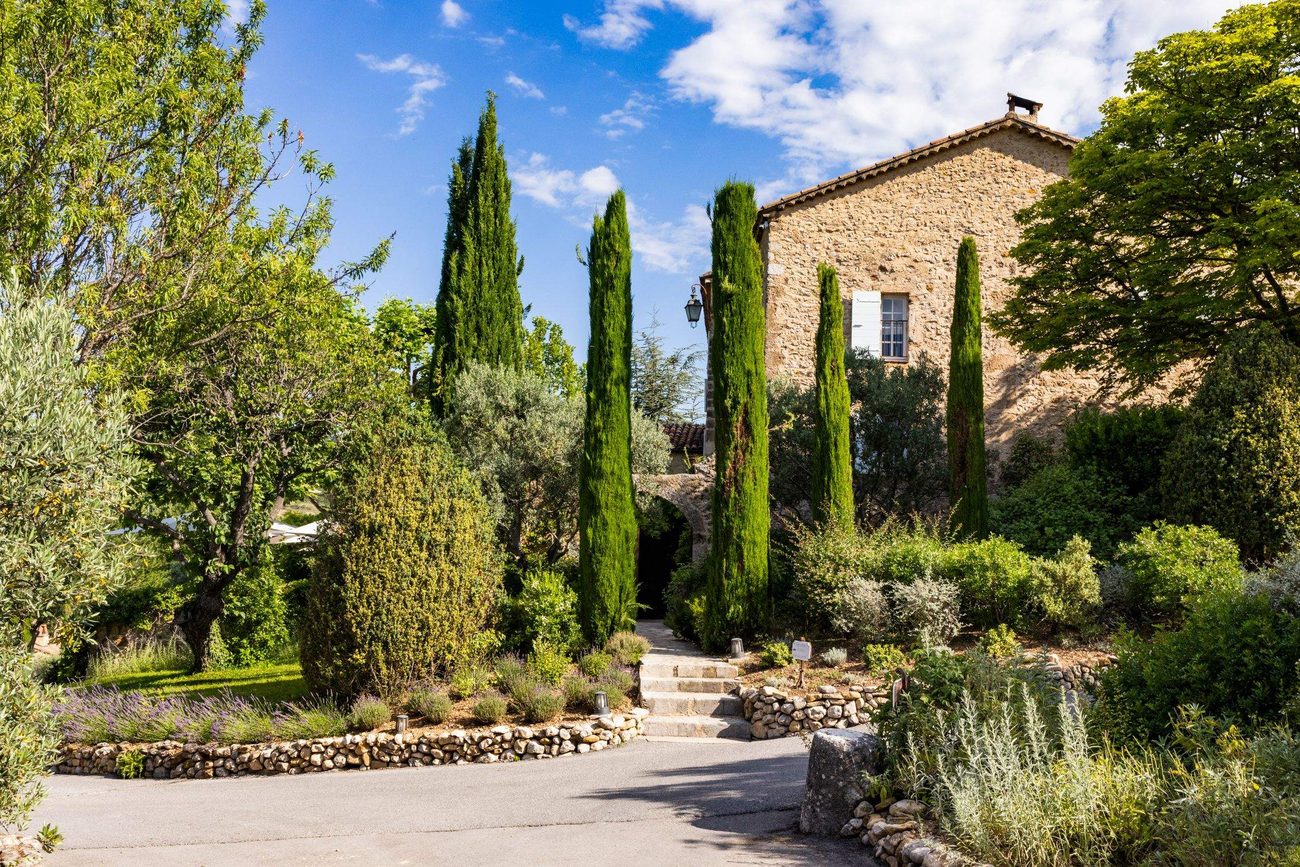 The main entrance to the bastide through the wooded park