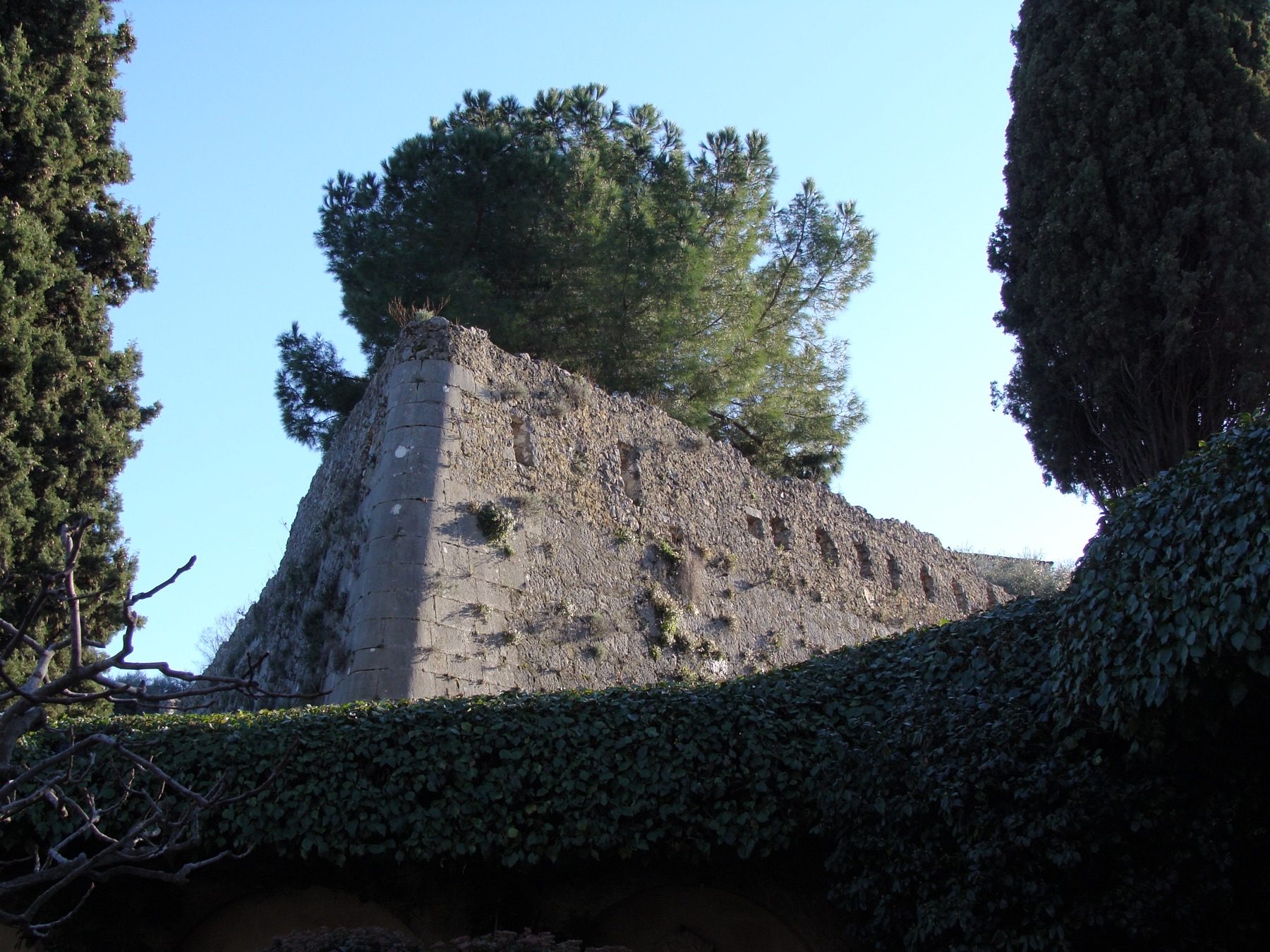 The medieval ramparts of Saint-Paul-de-Vence rising above the garden and terrace of La Colombe d'Or